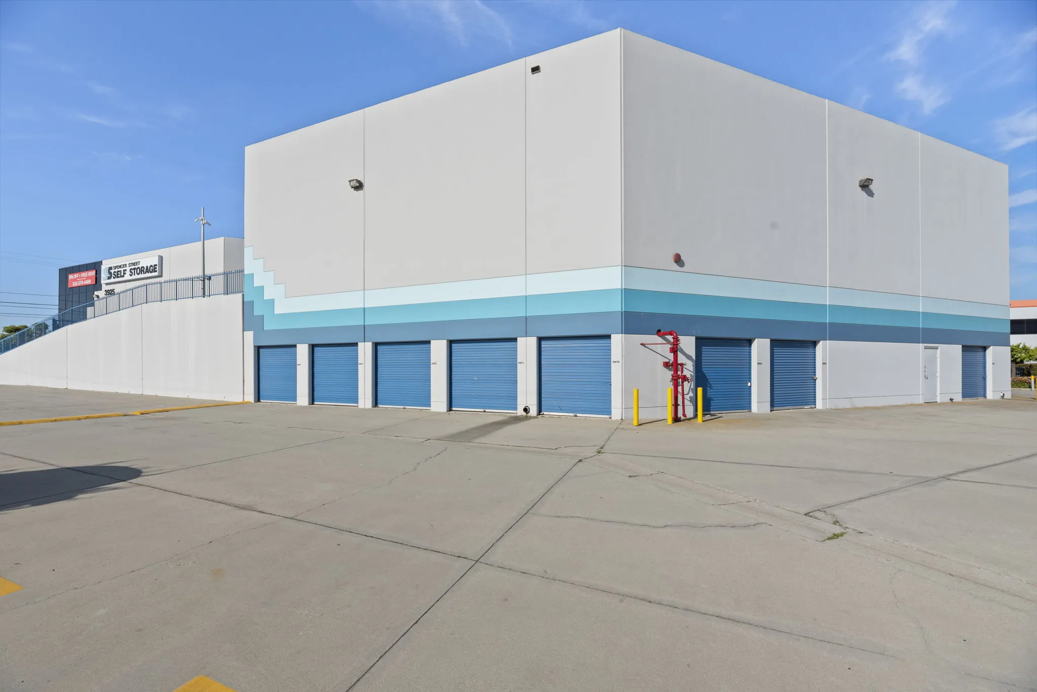 Exterior shot highlighting large storage units and driveway access at Spencer Street Self Storage.