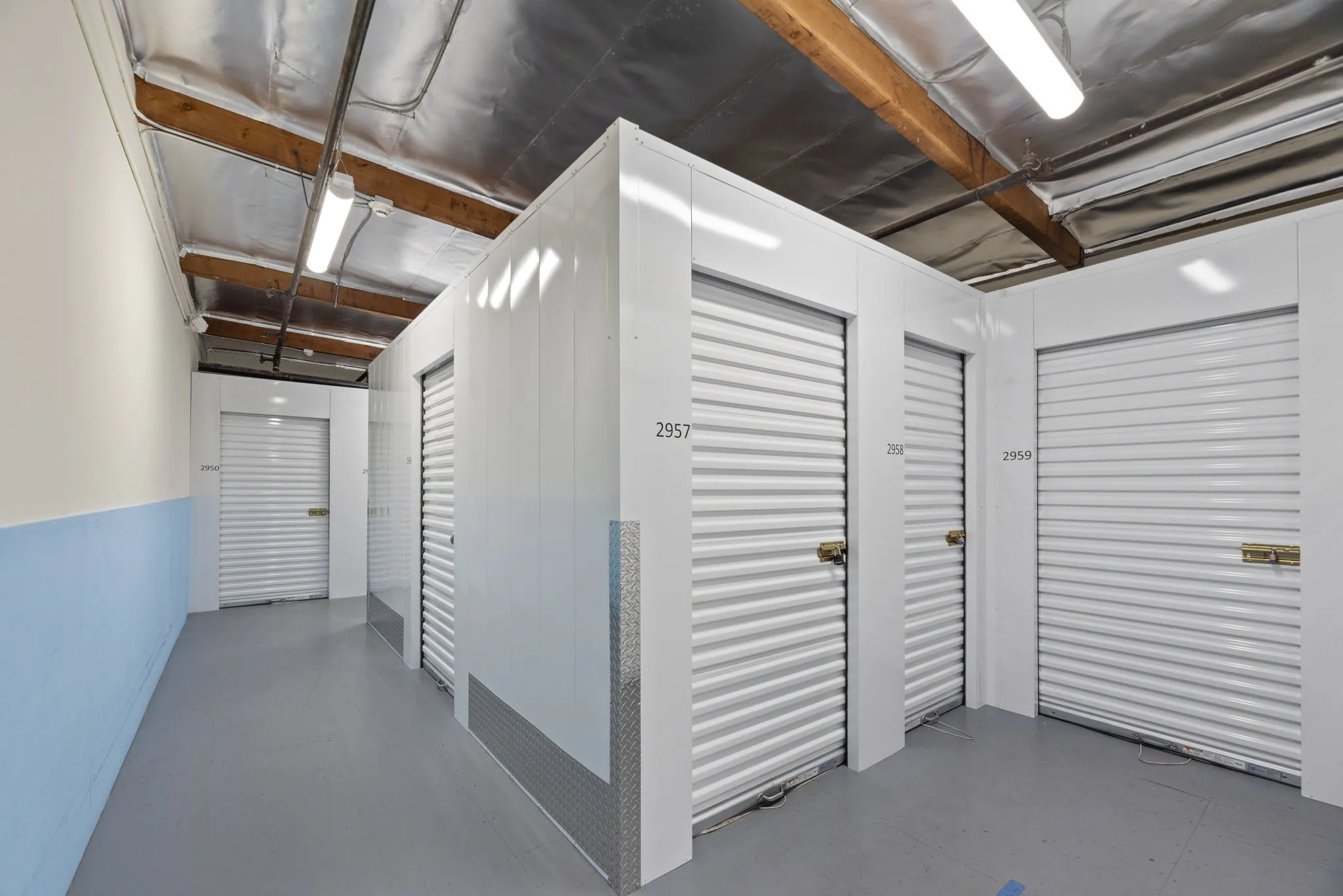 Clean interior hallway with climate-controlled storage unit doors at Spencer Street Self Storage.